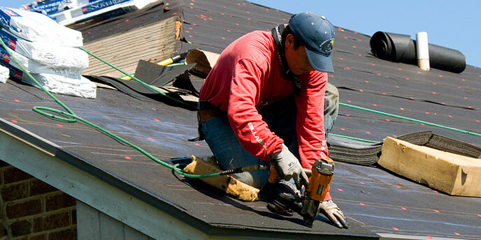 Contractor on Roof Repairing Shingles