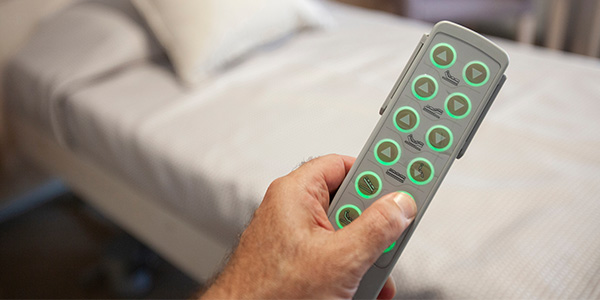 Person Holding Remote for an Adjustable Bed