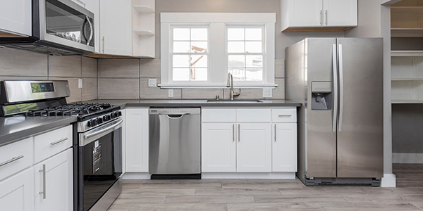 White Kitchen With Stainless Steel Appliances