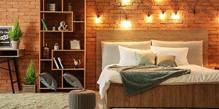 Bedroom With Lights on Brick Wall