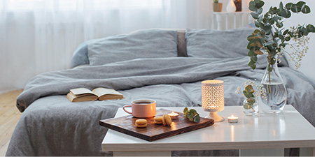 Bedroom With Lit Candles and Cup of Tea