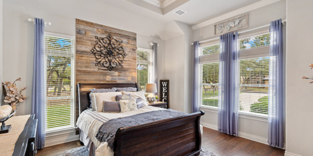 Bedroom With Sleigh Bed and Wood Wall