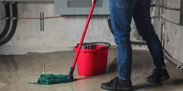 Person Mopping Concrete Basement Floor