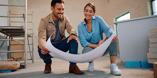 Couple Looking at Blueprints During Home Remodel