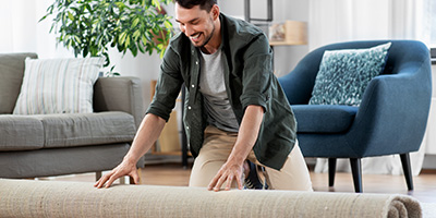 Man Decorating Living Room With a New Rug