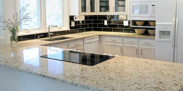 New White Kitchen With Marbled Countertops