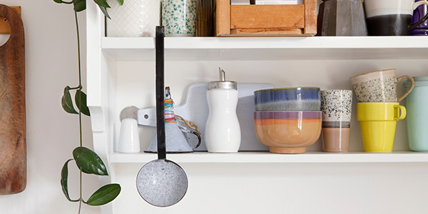 White Open Shelves With Colorful Dishes and Kitchenware