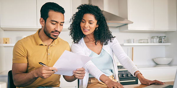 Couple Looking Over Budget in Kitchen