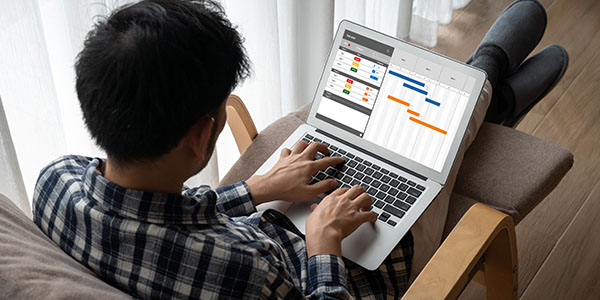Man Creating Renovation Timeline on Laptop