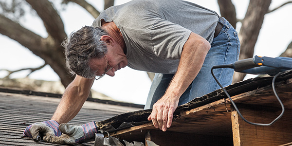 Man Repairing Leaky Roof