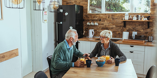 Senior Couple Having Breakfast in Kitchen