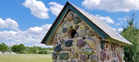 Stone Birdhouse in Field