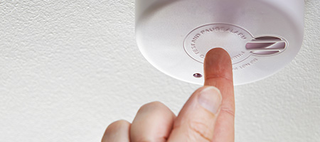 First-Time Homeowner Testing Their Smoke Detector