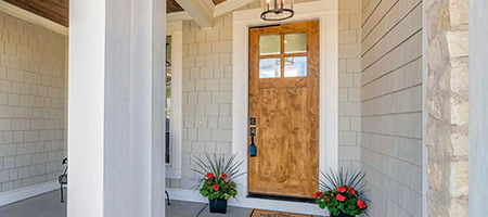 A modern exterior entryway with new decor and fixtures. 