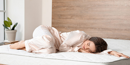 Woman Lying on Comfortable Mattress