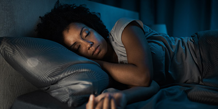 Woman Sleeping in Cozy Bedroom