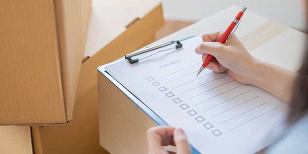 Woman Holding Moving Prep Checklist