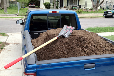 Pickup Truck Bed Filled With Dirt and Shovel