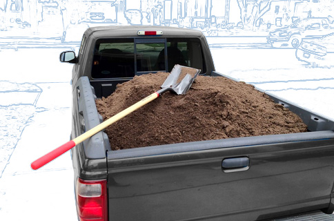 Pickup Truck Bed Filled With Dirt and Shovel